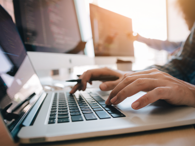 Person typing on a computer keyboard