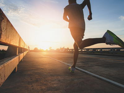 Person running beside a road