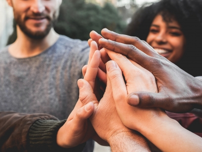 Image of a group of young people stacking hands