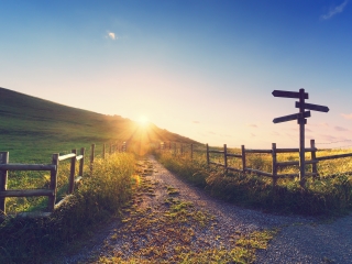 Image showing a signpost for multiple directions and a path leading up a hill.